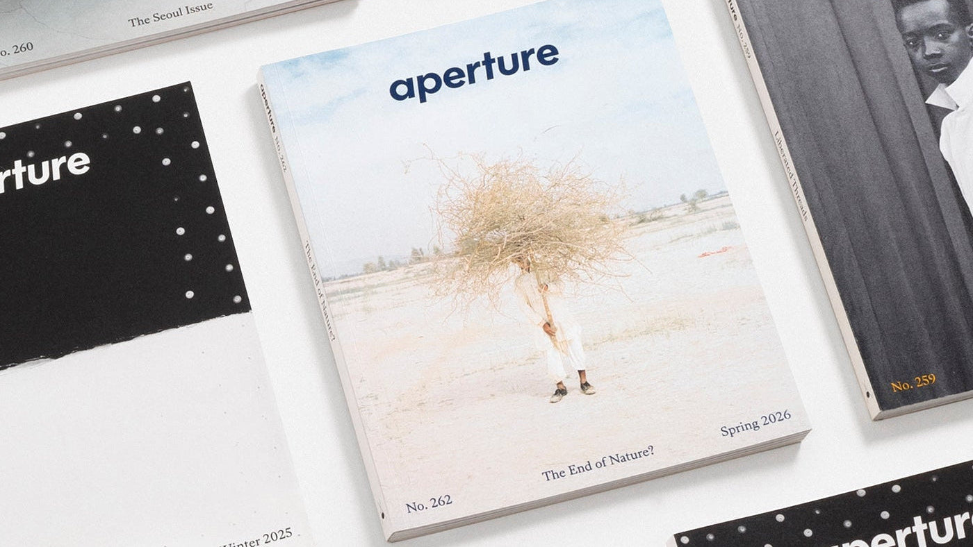 Collection of 'aperture' magazines on a white surface